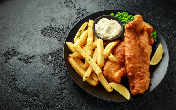 istock British Traditional Fish and chips with mashed peas, tartar sauce and cold beer. 1177829607