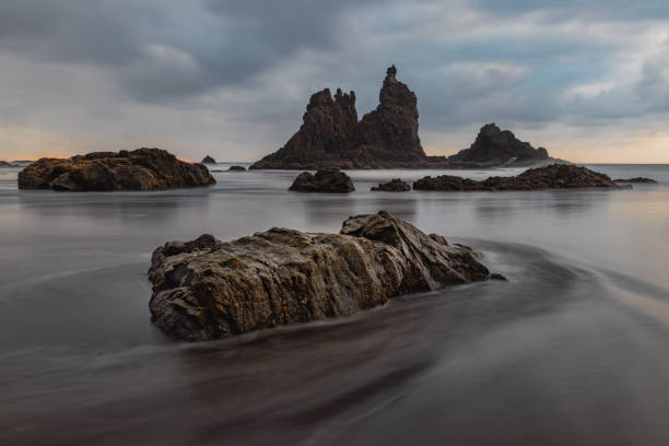 istock Rock formations in the beach with a Long Exposure time. 1177830477