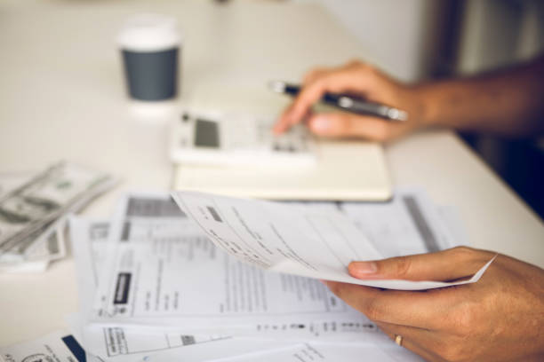 istock Man use calculators and documents that calculate expenses in the home office. 1177832734