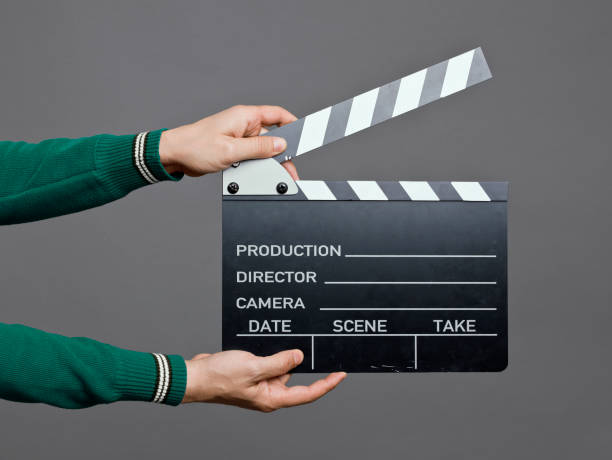 istock Man holding a movie clapperboard, studio shot 1177839768