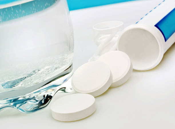 istock Tablets and a a glass of water 1177840239