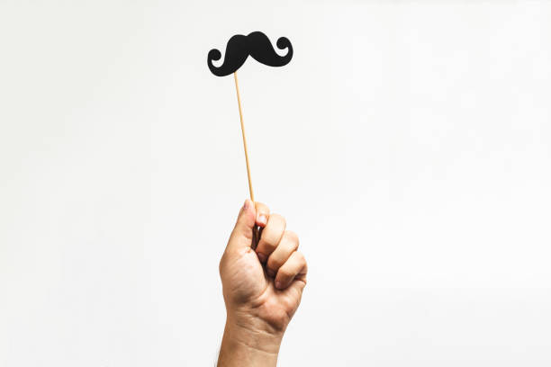 istock Hand holding Photo booth props, Black Mustache and rising it up 1177841465