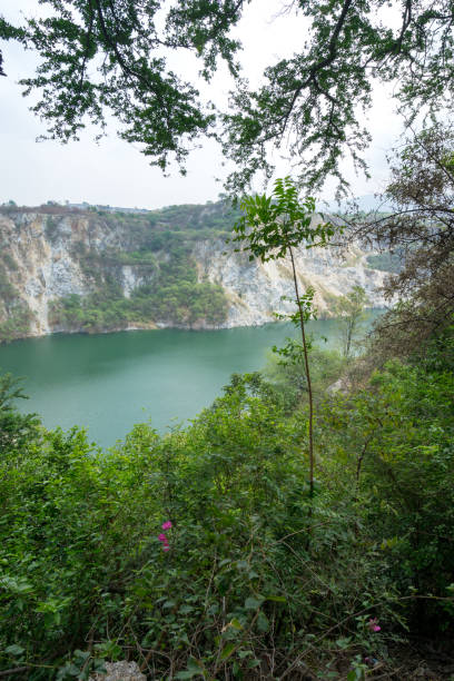 istock scenic tree and old mine with green lake background 1177841577