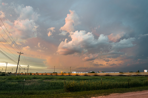 Scenic view at sunset of a storm moving away, as seen from the town of Alliance, Nebraska. Freight train is blurred due to motion and long exposure.