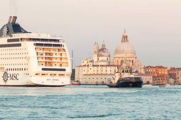 A huge cruise ship in St.Mark basic (San Marco basin) near Punta della Dogana in Venice lagoon entering Giudecca Canal. Seen from Riva San Biasio.