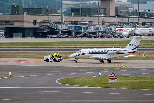 Zurich, Switzerland - July 19, 2018: Small private jet airplane towing in international airport