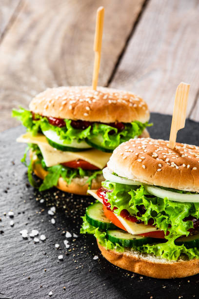 istock Big hamburgers on black stone 1177848348