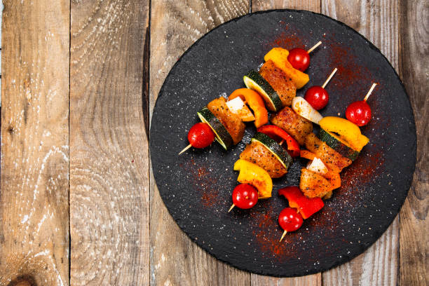 istock Raw shashliks on black stone plate 1177849651