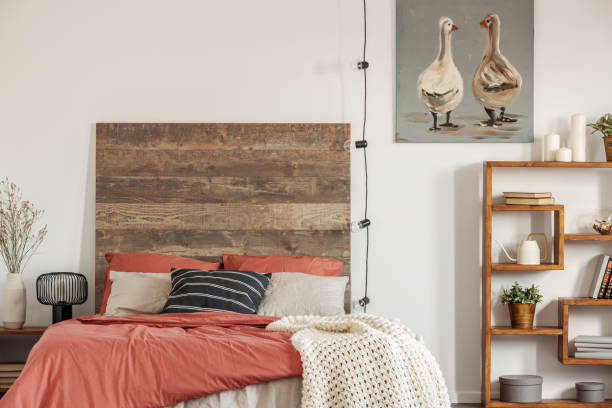 istock Cozy bedroom interior with king size bed with dirty range bedding and white blanket 1177849844