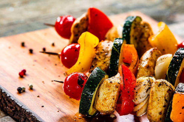istock Kebabs - grilled meat and vegetables on wooden background 1177850989