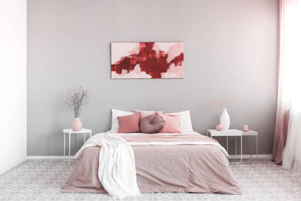 istock King size bed with pastel pink and white bedding in trendy bedroom interior 1177851166