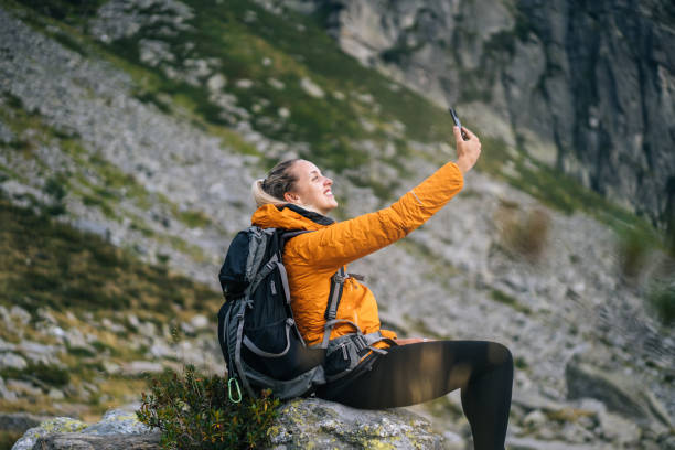 istock Hiker takes selfie with cell phone in mountains 1177852781