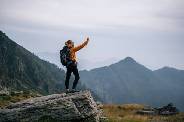 istock Hiker takes selfie with cell phone in mountains 1177852878