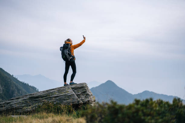 istock Hiker takes selfie with cell phone in mountains 1177852938