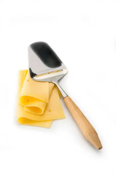 Cheese with a cheese-slicer , isolated on a white background