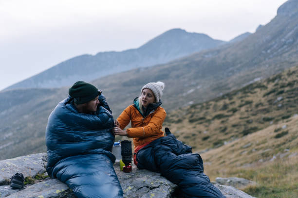 istock Couple camping without a tent prepare a hot drink 1177853120