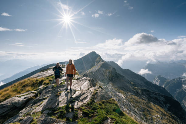 istock Couple hike along a mountain ridge in the bright sun 1177854600