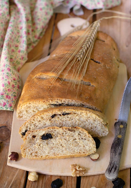 istock Healthy white bread with wheat bran, hazelnuts, nuts and dried cherries 1177858273