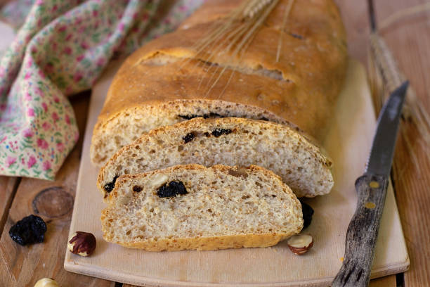 istock Healthy white bread with wheat bran, hazelnuts, nuts and dried cherries 1177858280