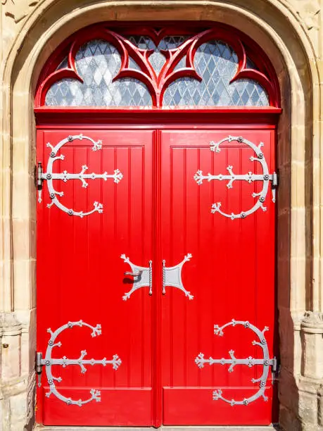 Mariawald Trappist Abbey beautiful sunlit red church door, close view, District of Dueren, North Rhine-Westphalia, Germany
