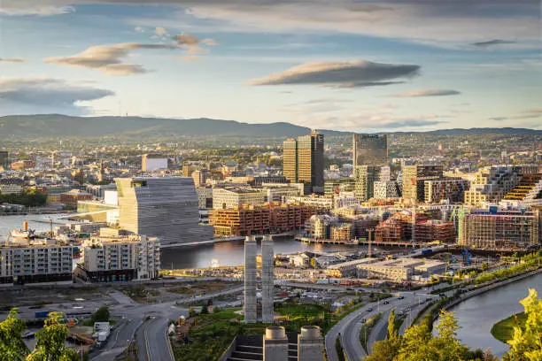 View from above Ekebergparken over Sorenga District towards Oslo Cityscape with Oslo Harbor in late afternoon light close to twilight. Oslo City, Norway, Scandinavia, Europe