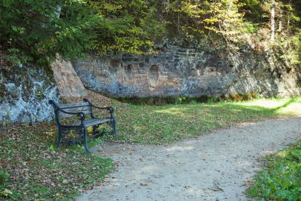 Photo of City Sigulda, Latvia Republic. Old chair and red rocks. 27. Sep. 2019