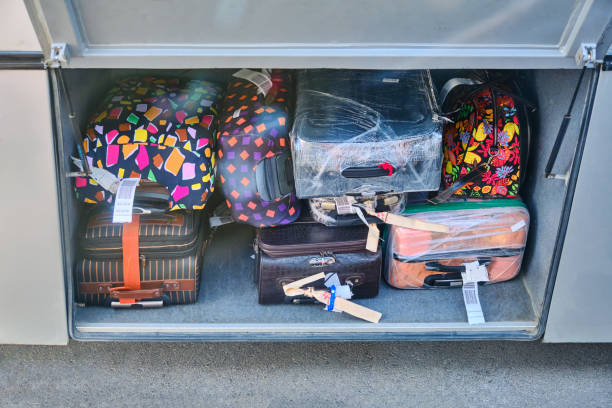 istock Checking luggage or suitcase compartment on bus. Many heavy luggage load into a bus locker. Packing bags while traveling. Suitcases in the luggage compartment of the bus. 1177869223