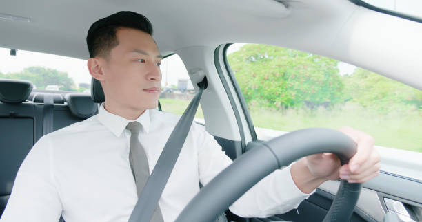 istock business asian man driving car 1177873382