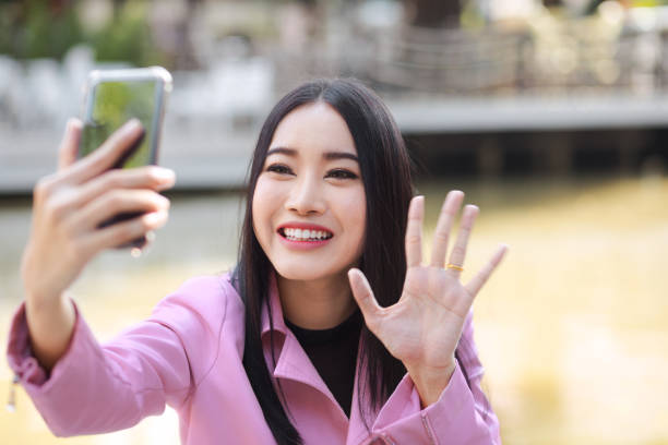 istock Thai woman happy waving in video chat 1177873602