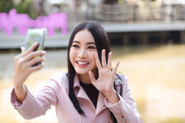 istock Young thai woman having live video chat 1177873634