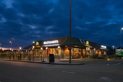 OLDENZAAL, NETHERLANDS - SEPTEMBER 25, 2019: Exterior of an McDonalds fast food restaurant at sunset.