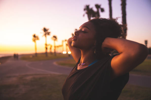 Woman portrait on the beach in southern California Woman portrait on the beach in southern California southern california palm trees stock pictures, royalty-free photos & images