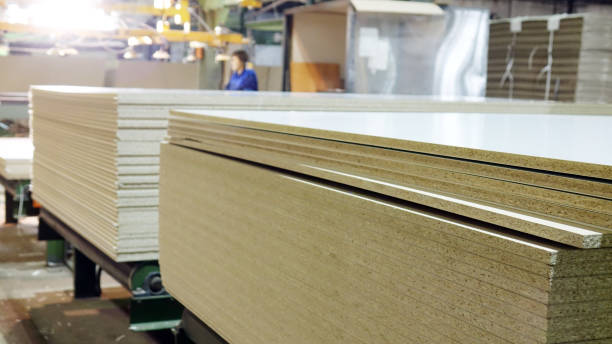 Production of laminated fiberboard. Fibreboard sheets for furniture production stock photo