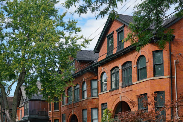 istock Tree lined street with large old brick houses with gables 1177879291