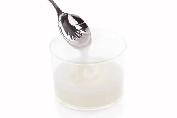 Inverted sugar syrup pouring from a spoon