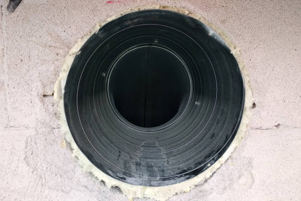 istock Metal ventilation pipe integrated in whine block wall under construction. 1177881053