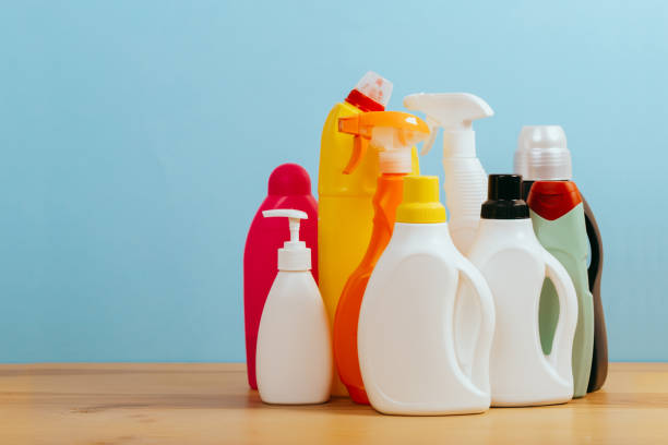 istock Cleaning product plastic container for house clean on wooden table and blue background . 