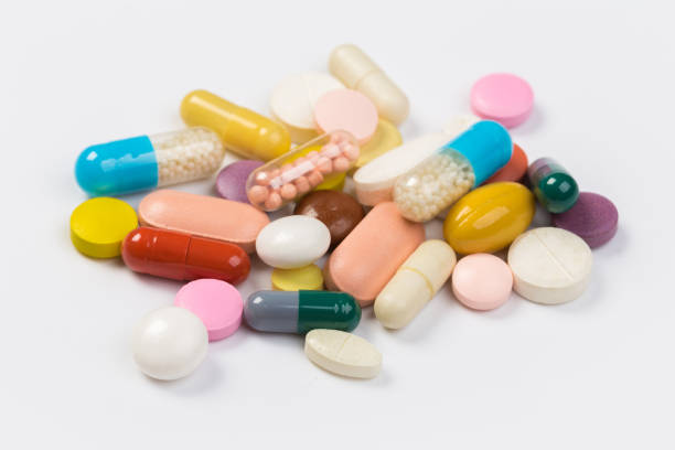 istock Assorted pharmaceutical medicine pills, tablets and capsules.Heap of assorted various medicine tablets and pills different colors on white background. 1177882212