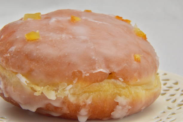 istock Donut with icing and orange zest lying on a plate 1177883341