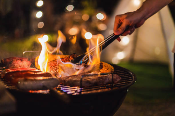 barbecue camping Family making barbecue in dinner party camping at night bbq stock pictures, royalty-free photos & images