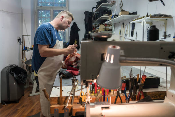 istock Shoemaker in shoe repair shop 1177888178