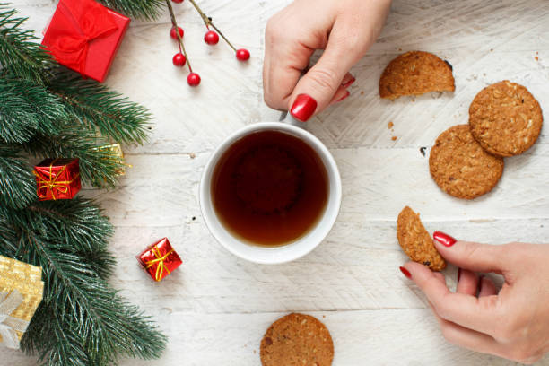 istock Christmas composition with hands keeping tea mug and cookies 1177888887