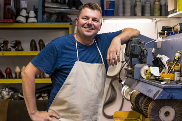 istock Shoemaker in shoe repair shop 1177889216