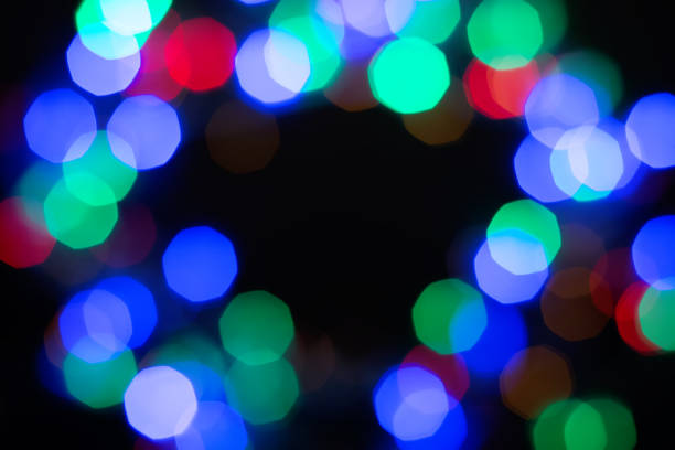 istock Multicolor shiny bokeh frame on black background. Abstract black, green, purple, red and blue glitter 1177889507