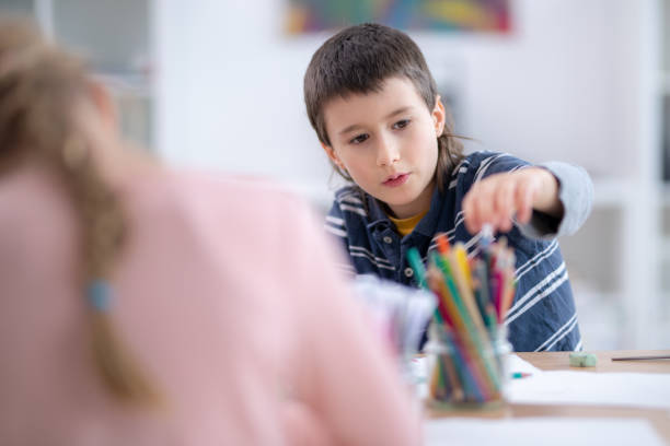 istock Schoolboy drawing with coloured pencils 1177892127