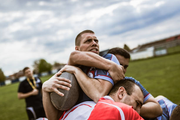 istock Rugby player making an effort while his opponents are blocking him on a match. 1177893899