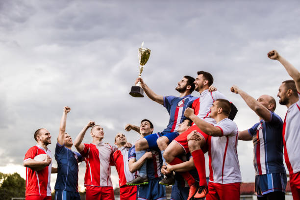 istock Rugby rivals celebrating winning a trophy on a playing field. 1177893964