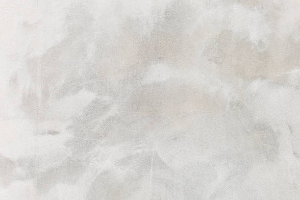 istock white washed painted concrete wall texture abstract background with brush strokes in gray and black shades. 1177896026