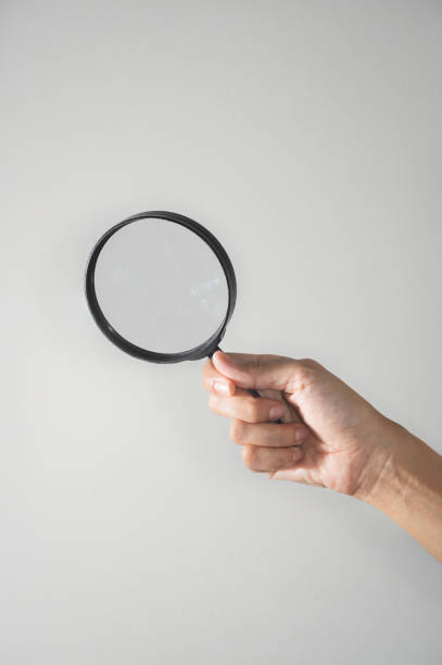 istock Woman hand holding the magnifying glass 1177896250
