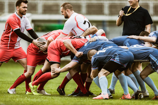 Scrum action on rugby match! Large group of rugby players in scrum during match on playing field. offense sporting position photos stock pictures, royalty-free photos & images